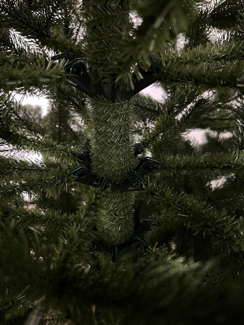 Near the trunk: still molded PE. On a blended tree this is flat vinyl filler.